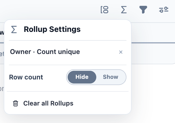 The Rollup Settings panel listing an Owner count-unique rollup, with a Row count show/hide toggle and Clear all Rollups